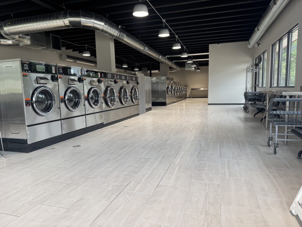 clean-laundry-folding-tables-quick-wash-laundromat Well lit laundromat in Des Moines